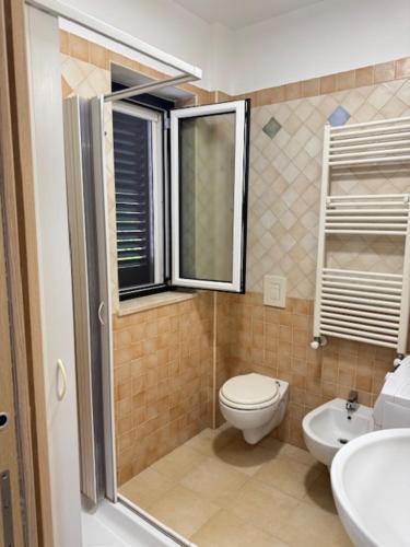 a small bathroom with a toilet and a sink at Casa Vacanze Ginevra & Carlotta Villaggio RIVAZZURRA POLICORO in Policoro