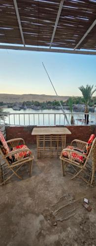 a patio with two chairs and a table and a table at Rayan Nubian Guest House in Aswan