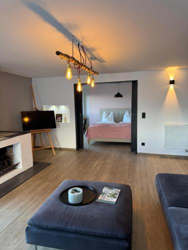 a living room with a bed and a couch at Penthouse in Buttelstedt