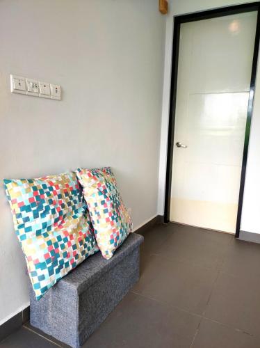 a room with a couch with a pillow and a door at Cyberjaya Puchong JWJ Pool Villa in Cyberjaya