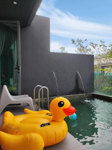 a large yellow rubber duck in a swimming pool at Cyberjaya Puchong JWJ Pool Villa in Cyberjaya