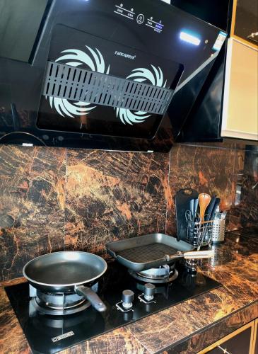 a stove top with a box on top of it at Cyberjaya Puchong JWJ Pool Villa in Cyberjaya