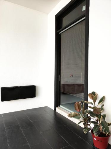 a room with a window and a potted plant at Cyberjaya Puchong JWJ Pool Villa in Cyberjaya