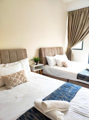 a hotel room with two beds and a window at Cyberjaya Puchong JWJ Pool Villa in Cyberjaya