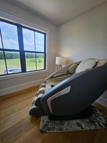 a bedroom with a large bed and a large window at Roxell Ranch-A Country Retreat 12 Guests 6 beds in Brenham