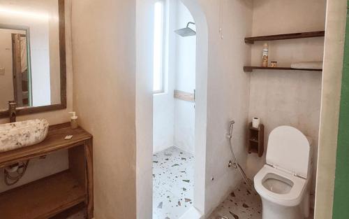 a bathroom with a toilet and a sink at Rural Sense Organic Farm Stay in Faridabad