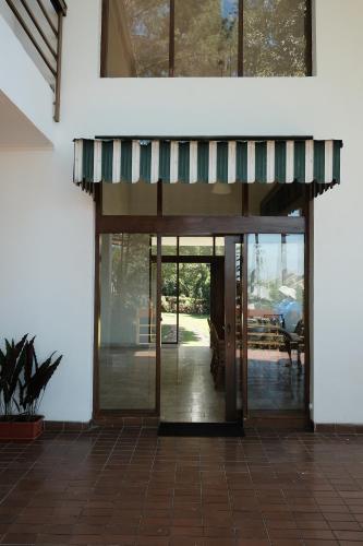 an entrance to a house with a glass door at Balconé Lodge in Bandung