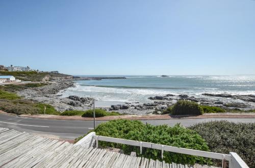 a view of the ocean from the balcony of a house at Voetjieshang in Yzerfontein