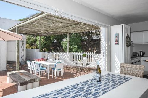 a kitchen and dining room with a table and chairs at Voetjieshang in Yzerfontein