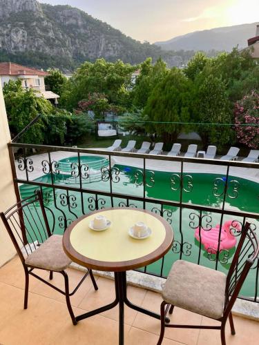 a table and chairs on a balcony with a view at Angels Garden Dalyan in Dalyan