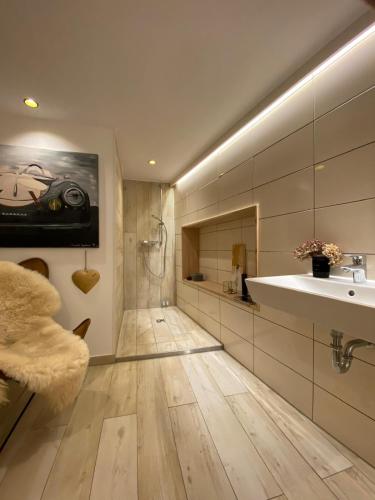 a bathroom with a sink and a bath tub at Penthouse in Buttelstedt