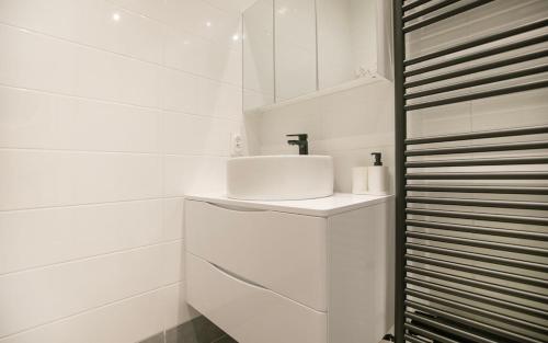 a white bathroom with a sink and a shower at Le Gare Nord T3 de Haut Standing Cosy et Relaxant in Nantes