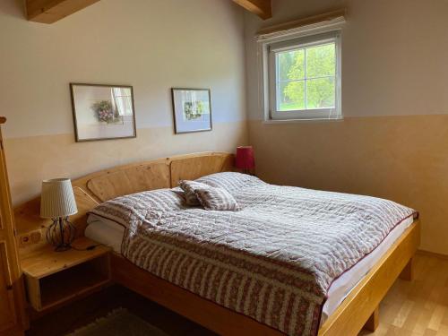 a bedroom with a bed and a window at Techendorf 101 in Weissensee