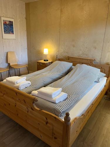 a large bed in a room with towels on it at Storeval feriehus Nærøysund in Kolvereid