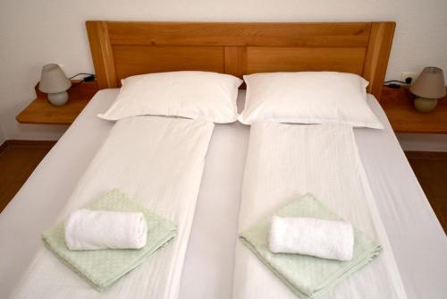 a bed with two white pillows on it at Sutjeska in Modriča