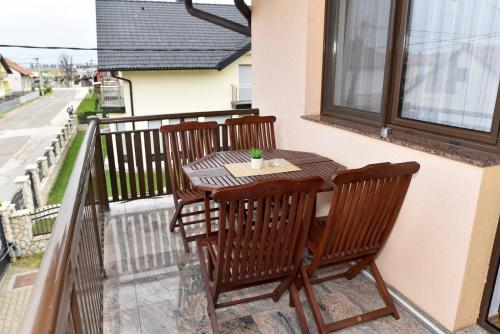a balcony with a table and chairs on a balcony at Sutjeska in Modriča