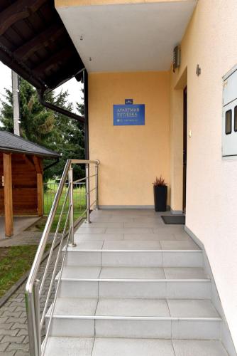 a stairway leading up to a building with a blue sign at Sutjeska in Modriča