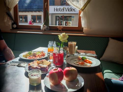 a table with three plates of food on it at Pohorje Village Wellbeing Resort - Family Apartments Bolfenk in Pohorje