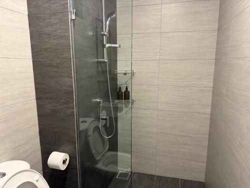 a bathroom with a glass shower with a toilet at Shelisa's Modern 3BR House at Suria Garden Puchong in Puchong