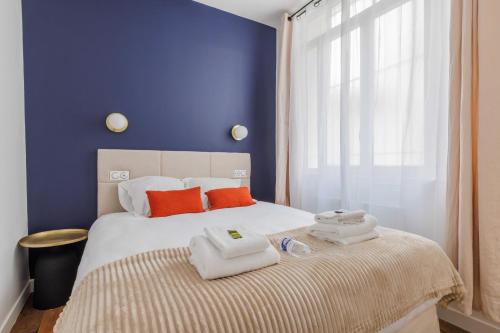 une chambre avec un lit avec des serviettes dessus dans l'établissement Charmant Appartement 2BR-6P - Gare de l'Est, à Paris