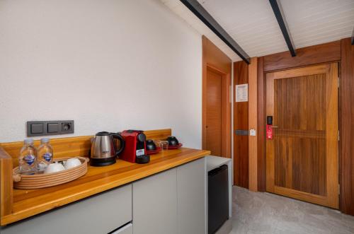 a kitchen with a wooden counter top with a counter top at Lupia Suites in Kalkan