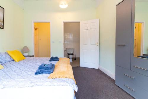 a bedroom with a bed with a blue blanket on it at Thornbury Guest House Room 2 in Southampton