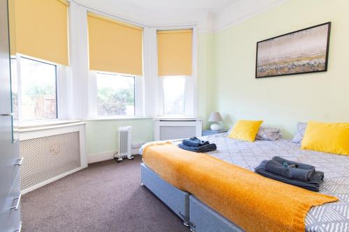 a bedroom with a large bed in a room with windows at Thornbury Guest House Room 2 in Southampton