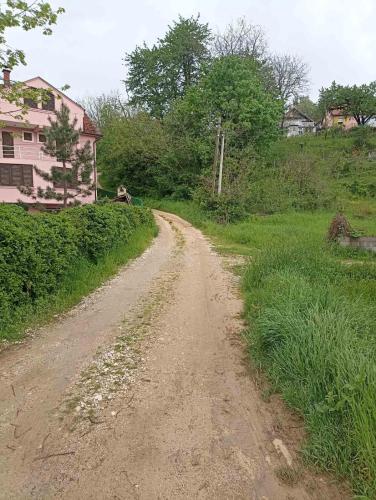 a dirt road in a field with a house at Vila Milano in Rakari
