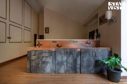 a kitchen with a wooden counter with a sink at StayVista at Ambrosia access to water stream in Kotagiri