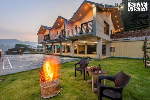 a house with a fire pit in the yard at StayVista at Ambrosia access to water stream in Kotagiri