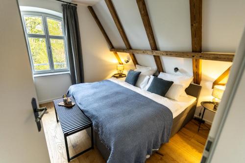 a bedroom with a bed with a blue blanket at Traumzeit Apartments in Dinkelsbühl