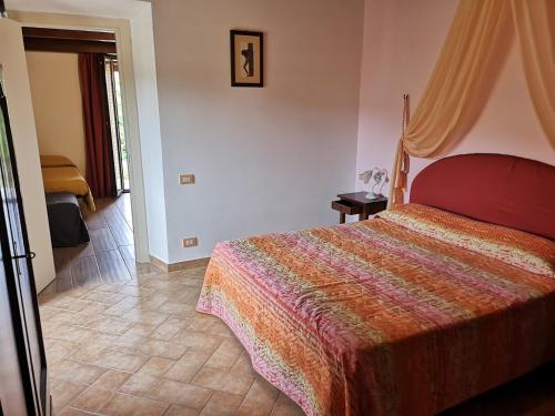 a bedroom with a large bed in a room at Agriturismo Vecchio Gelso in Ortezzano