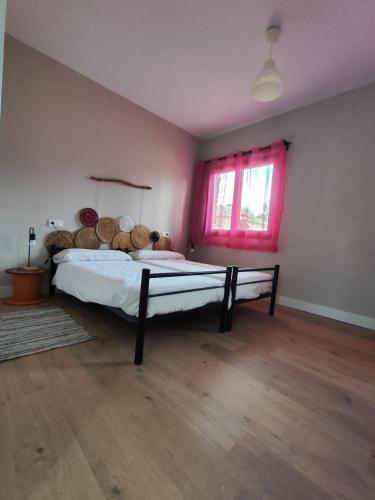 a bedroom with a large bed with logs on it at Centro Ecoturismo Barbatona Sigüenza in Barbatona