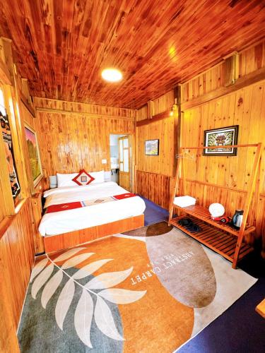 a bedroom with a bed in a wooden room at Sapa Eco Hugo in Sa Pa