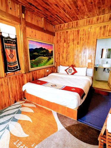 a bedroom with a bed in a wooden room at Sapa Eco Hugo in Sa Pa