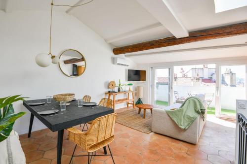 un salon avec une table et des chaises dans l'établissement Chez Marcel - Appart 2 ch avec clim - St Charles, à Marseille