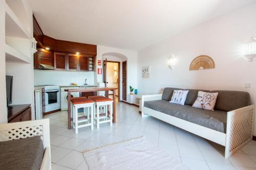 a living room with a couch and a kitchen at Bellavista Avenida By BeGuest in Albufeira