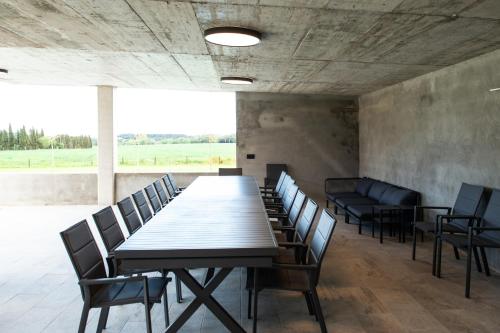 a conference room with a long table and chairs at Casa Rural Mas Homs in Parets de Dalt