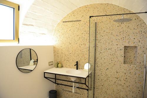 a bathroom with a shower with a sink and a mirror at Casa Rural Mas Homs in Parets de Dalt