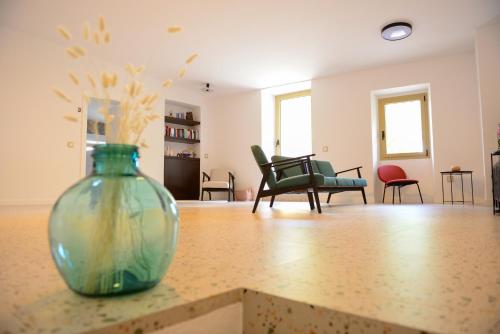 a vase sitting on a counter in a living room at Casa Rural Mas Homs in Parets de Dalt
