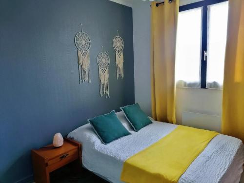 a bedroom with a bed and some dreamcatchers on the wall at Belle maison conviviale in Coulommiers