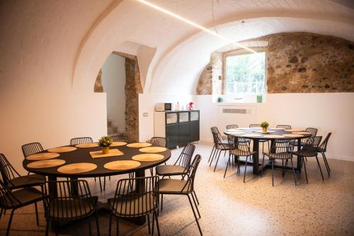 a room with two round tables and chairs at Casa Rural Mas Homs in Parets de Dalt