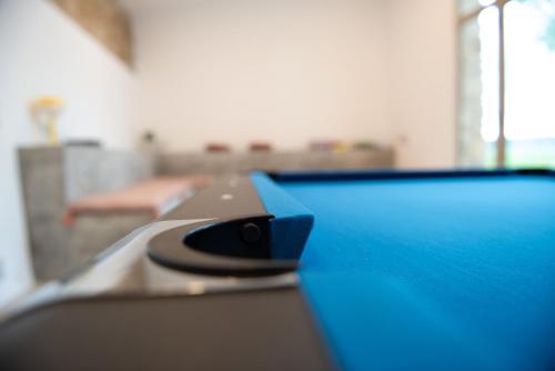 a blue table top with a black object on it at Casa Rural Mas Homs in Parets de Dalt