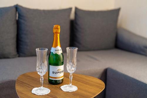 a bottle of champagne and two glasses on a table at Schwarzwaldliebe in Oberharmersbach