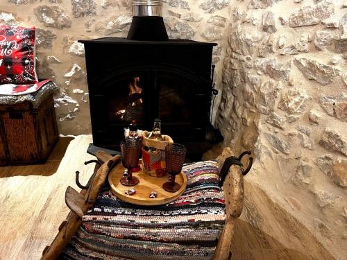 a table with two candles on it in front of a fireplace at Filia's House (The House of Friendship) in Areopolis