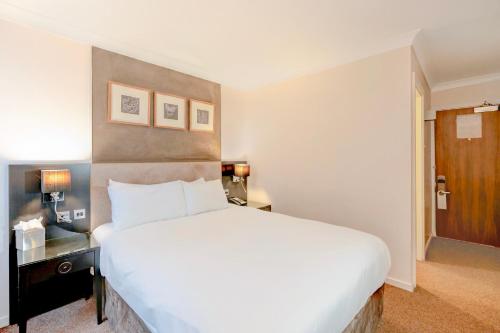 a large white bed in a hotel room at The Landmark Hotel and SPA Leisure Club Dundee By Sunday in Dundee