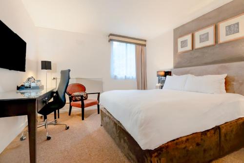 a bedroom with a bed and a desk and a computer at The Landmark Hotel and SPA Leisure Club Dundee By Sunday in Dundee