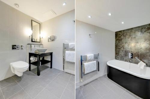 a bathroom with a sink and a tub and a toilet at The Landmark Hotel and SPA Leisure Club Dundee By Sunday in Dundee