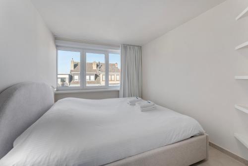 Ένα ή περισσότερα κρεβάτια σε δωμάτιο στο Stijlvol design app - eindeloos uitzicht op groen!