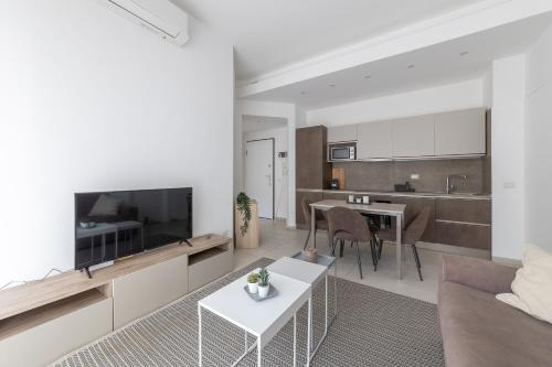 a living room with a couch and a tv and a table at Via Santa Croce 1 in Milan